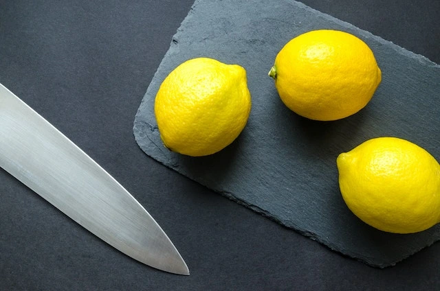 3 lemons with a knife beside
